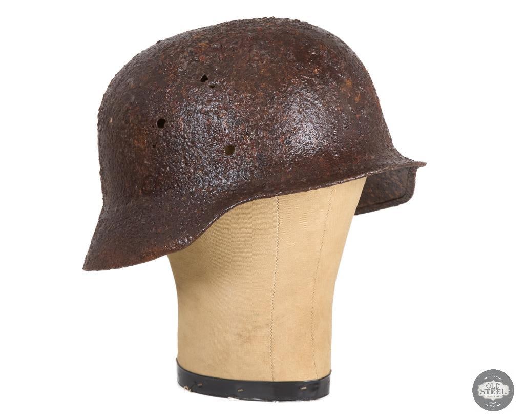 Battlefield Recovered M40 German Helmet Shell - Clear Coated Preserved: A battlefield recovered M40 WWII German helmet shell. Has a clear coating to preserve the heavily oxidized surface. THIS ITEM IS AS PICTURED WITH NO FURTHER ATTACHMENTS. ALL SALES ARE FINAL.