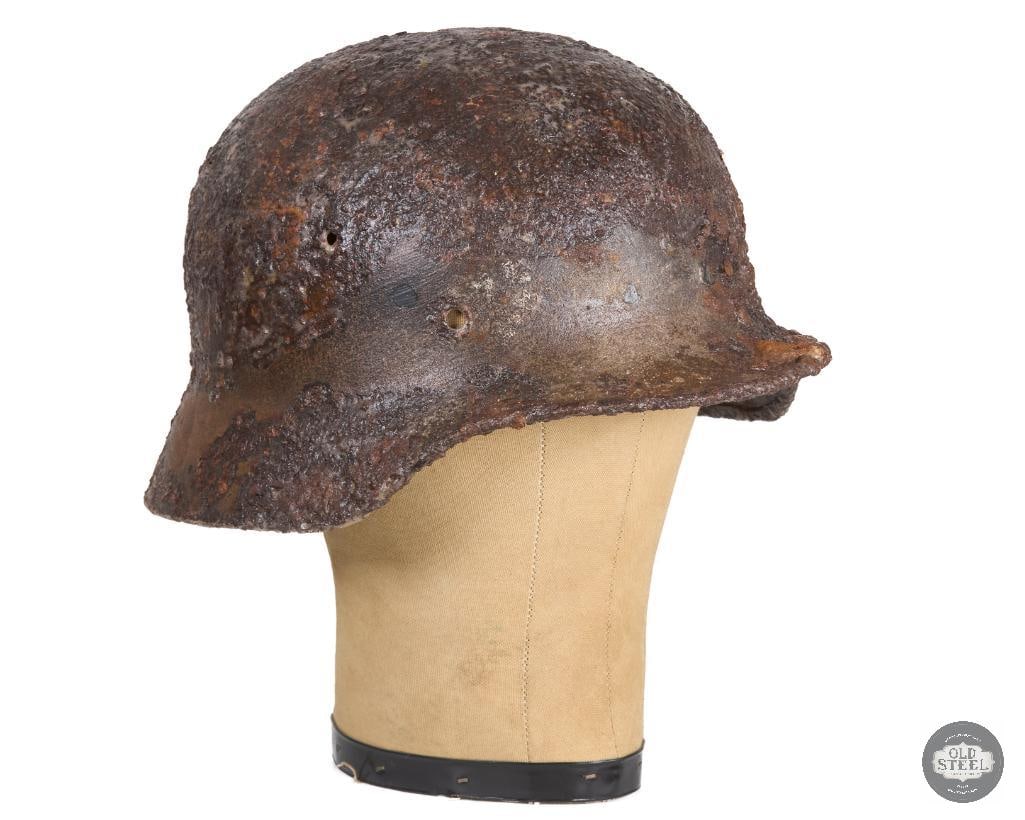 Battlefield Recovered M40 German Helmet Shell - Clear Coated Preserved: A battlefield recovered M40 WWII German helmet shell. Has a clear coating to preserve the heavily oxidized surface. THIS ITEM IS AS PICTURED WITH NO FURTHER ATTACHMENTS. ALL SALES ARE FINAL.