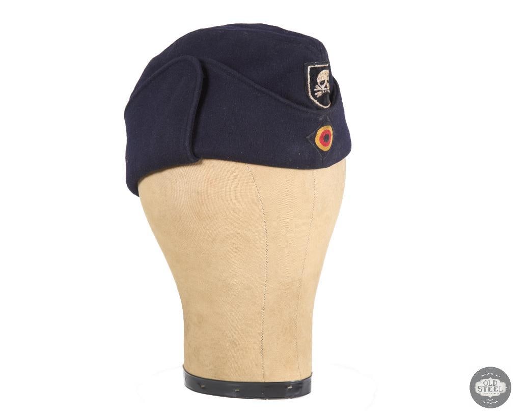 German Totenkopf Earflap Side Cap: German Totenkopf Earflap Side Cap. THIS ITEM IS AS PICTURED WITH NO FURTHER ATTACHMENTS. ALL SALES ARE FINAL. PLEASE REFER TO THE AUCTION DESCRIPTION, LOT #1 DESCRIPTION AND TERMS OF SALE