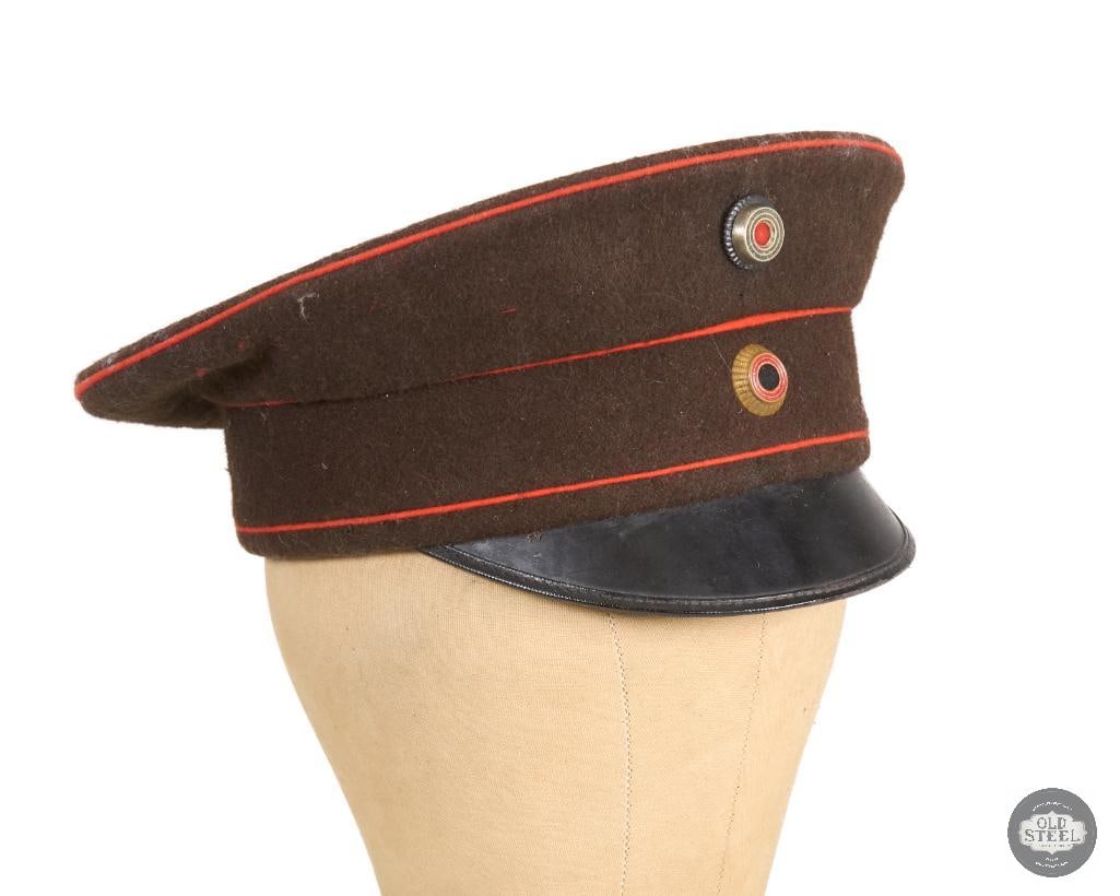 Original Imperial German Officer's Schirmmutze Visor Cap WWI: Imperial German service cap with red piping for the crown and band and brown wool construction. THIS ITEM IS AS PICTURED WITH NO FURTHER ATTACHMENTS. ALL SALES ARE FINAL. PLEASE REFER TO THE