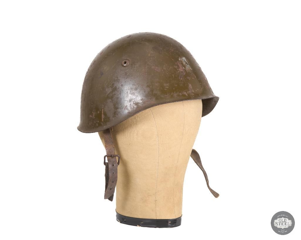 Italian M33 WWII Helmet with Front Bracket: Italian M33 WWII Helmet with Front Bracket. Liner and chinstrap present but the leather is degraded a bit. THIS ITEM IS AS PICTURED WITH NO FURT