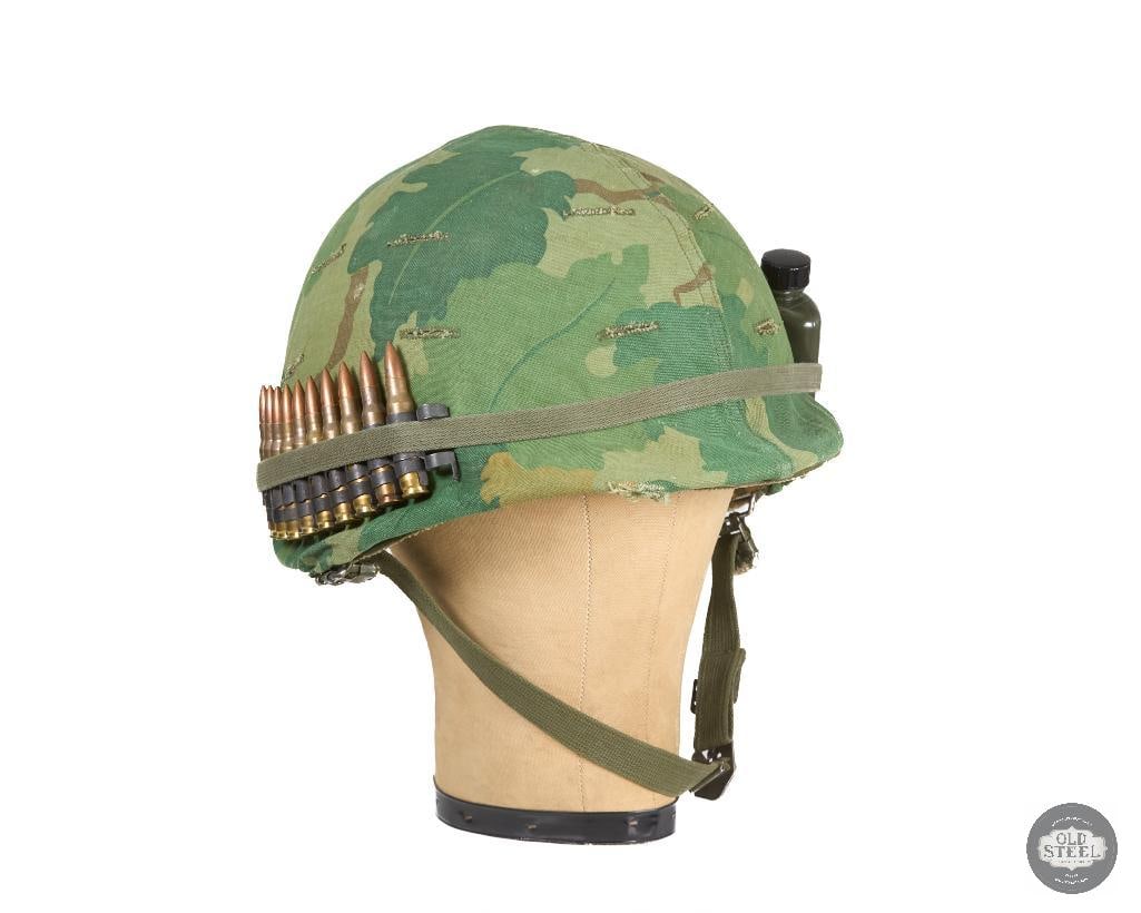 US M1 Vietnam War Helmet with Decorative Embellishments in Band: US M1 Vietnam War Helmet with Decorative Embellishments in Band THIS ITEM IS AS PICTURED WITH NO FURTHER ATTACHMENTS. ALL SALES ARE FINAL. PLEASE REFER TO THE AUCTION DESCRIPTION, LOT