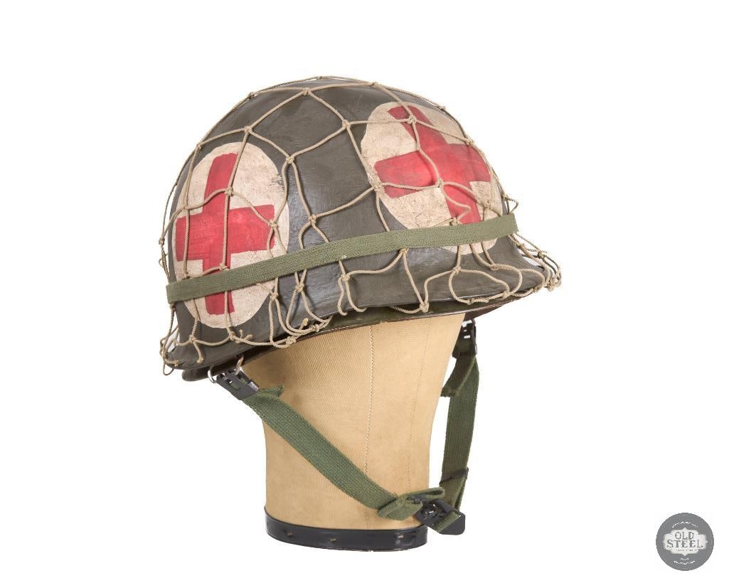 US Red Cross Medic M1 Helmet with Netting WWII: This M1 helmet from WWII is a great display piece with heavy painted red crosses on all 4 sides. THIS ITEM IS AS PICTURED WITH NO FURTHER ATTACHMENTS. ALL SALES ARE FINAL. PLEASE