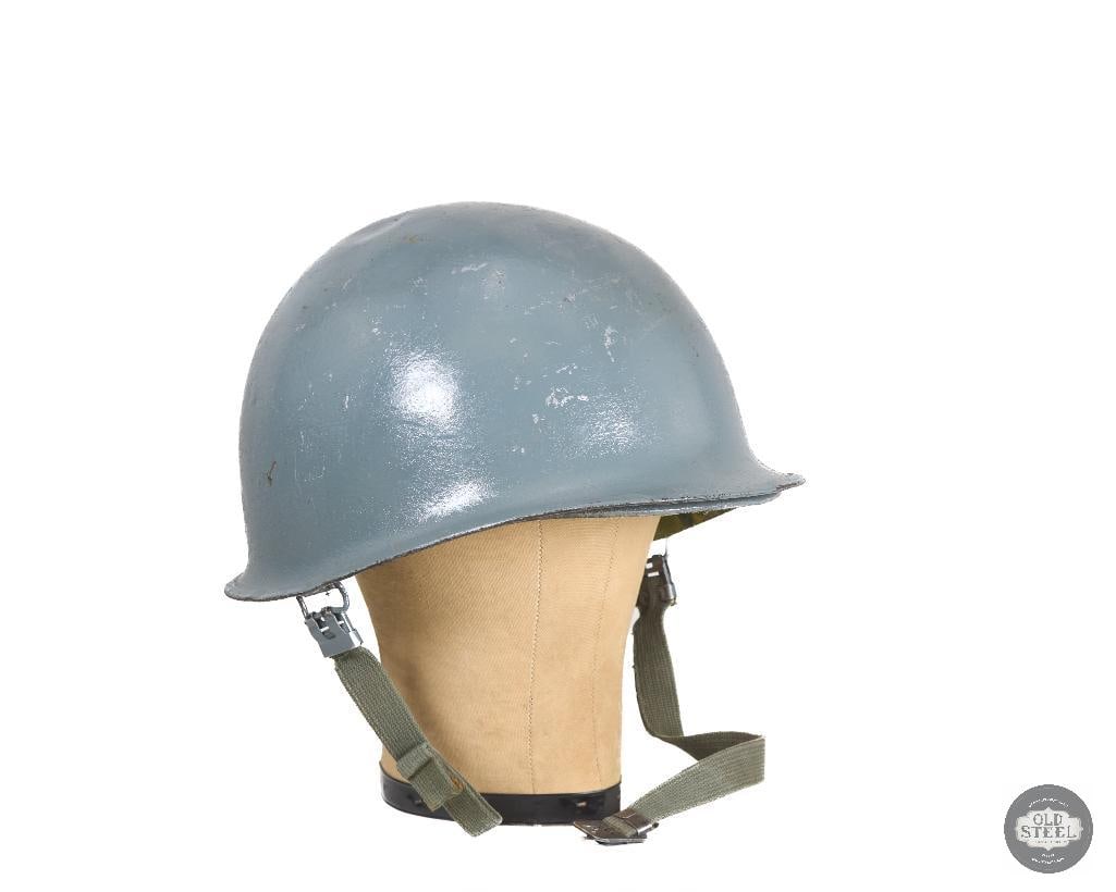 US M1 Helmet in Battleship Gray Post Vietnam War: US M1 Helmet in Battleship Gray Post Vietnam War. Missing chinstrap hook on right side. THIS ITEM IS AS PICTURED WITH NO FURTHER ATTACHMENTS. ALL SALES ARE FINAL. PLEASE REFER TO THE