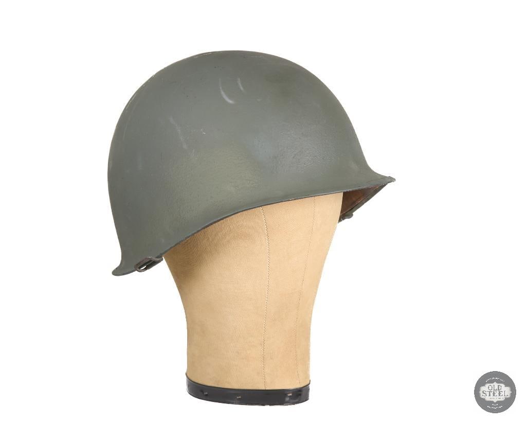 US M1 Helmet Korean War: A US Korean War era helmet. Liner's maker's mark is worn and hard to read beyond the large number 30. Leather chinstrap is present but dry and broken away from the left side. No shell chinstrap is pre