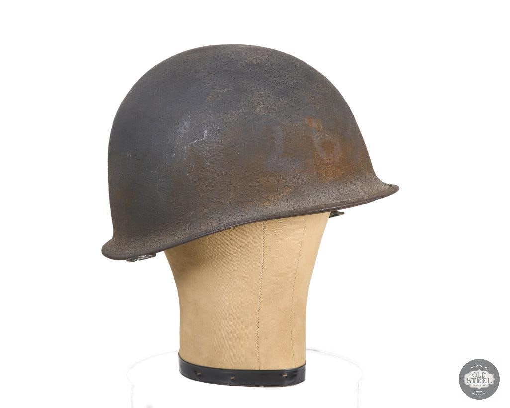 US M1 WWII Helmet McCord Shell IMP Liner: A US WWII era M1 helmet. The heat stamp on the shell is worn only showing the 2nd digit '3' and 'A' letter under the bill. The liner's makers mark is slightly worn and appears to be IMP. Degraded cott