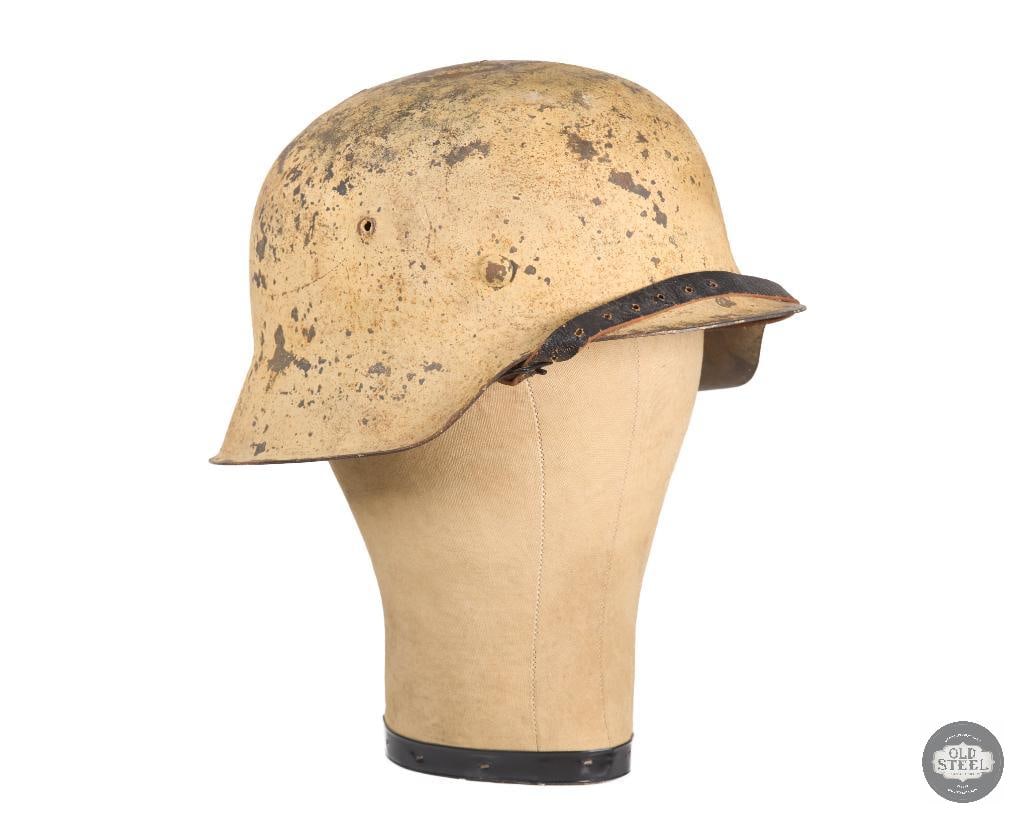 German M42 Heer Tan Helmet WWII: German M42 Heer helmet with tan paint. Good liner leather. Shell has seen use and has 2 cracks on the dome. Interior rear of shell is marked: hkp64 and 2929