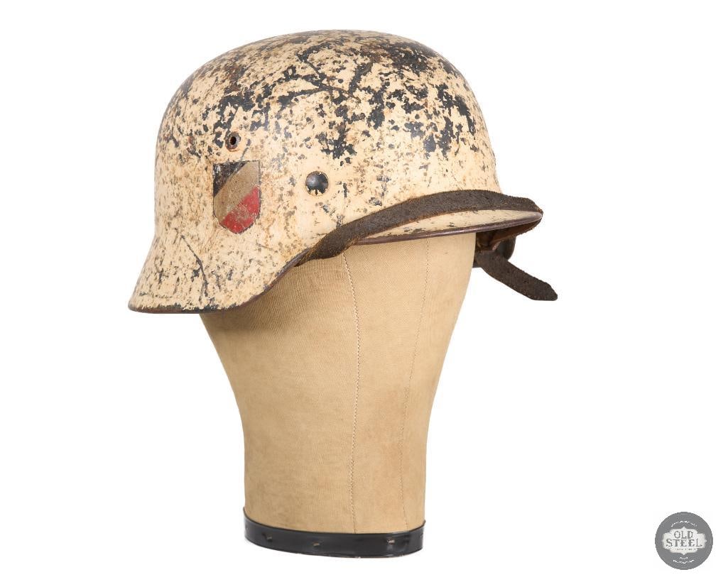 M35 German Double Decal Heer Winter Camo WWII Helmet: Winter camo double decal M35 German helmet of WWII. Great liner leather and still has the chinstrap though it is a bit stiff across the brim of the shell, having been positioned there for some time.&#