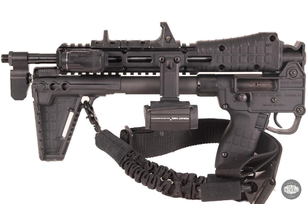 Kel-Tec Sub-2000 9mm Glock Magazine Fed Folding Carbine w/ Midwest Industries Mount & Primary Arms: This Kel-Tec Sub-2000 is a 9mm semi-automatic folding carbine designed around Glock magazine compatibility, offering a compact and highly portable rifle platform. Its signature folding design allows t