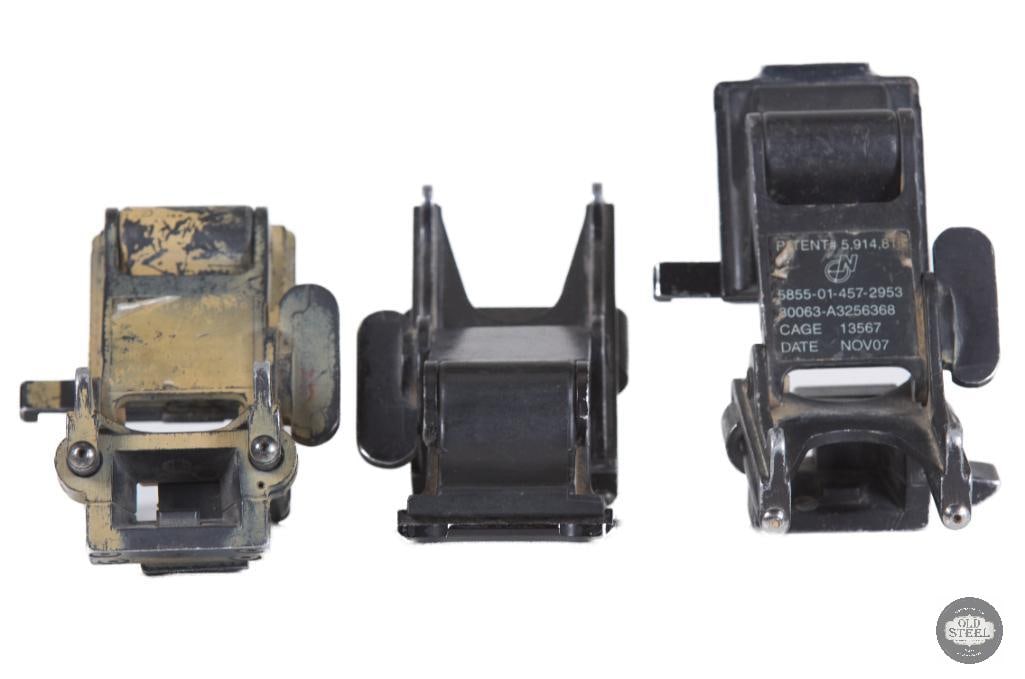 Lot of 3 Norotos RHINO I Mounts For Parts or Repair: This lot includes three Norotos RHINO I helmet mounts, offered for parts or repair. These mounts are designed for helmet-mounted night vision device attachment systems and are commonly used with