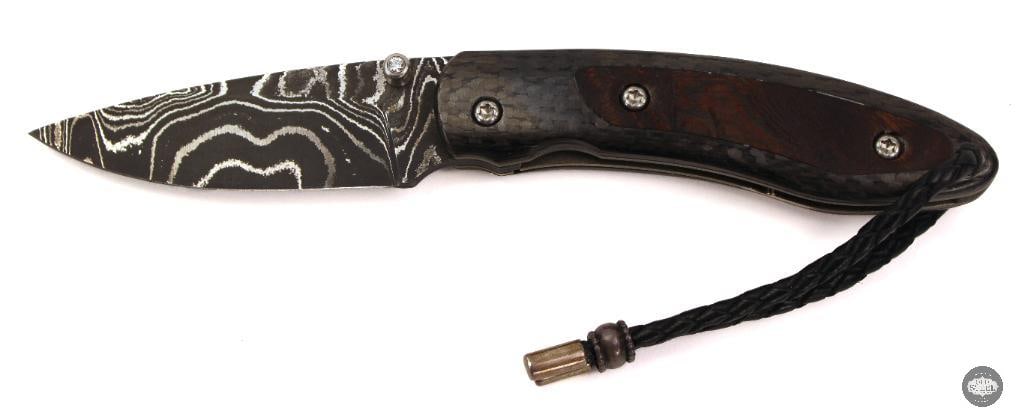 Castlegate Custom Folding Knife 2.5 Damascus Drop Point Blade, Carbon Fiber & Wood Inlay: This custom folding knife features a 2.5-inch Damascus steel drop point blade, showcasing a striking layered pattern paired with a compact and highly usable design. The handle is crafted from polished