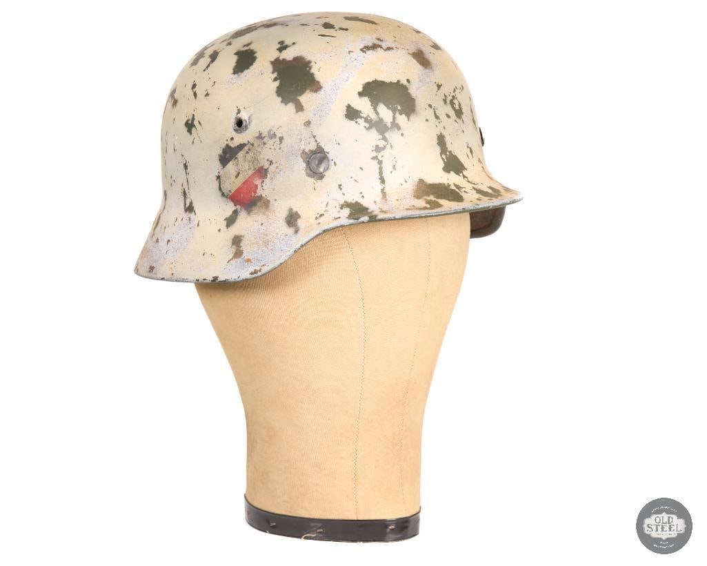 M40 Stahlhelm Winter Camo Double Decal Original Shell & Liner Modern Refurbishment: This M40 Stahlhelm features an original shell with double decals and retains its liner. The helmet has been refinished with a modern winter camouflage paint scheme and is not in its original wartime