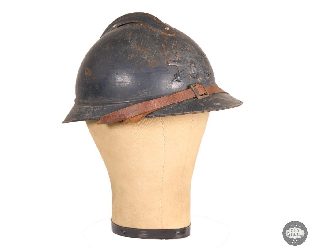 WWI French Adrian Helmet w/ Liner & Chinstrap Field Helmet: This original WWI French Adrian helmet comes complete with its liner and chinstrap. The liner is present but is missing its drawstring. The helmet shows age-related wear consistent with service and pe