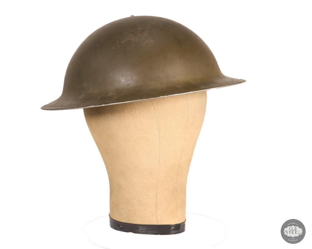 Original Canadian Mark 1 Brodie Helmet - 1942 Dated: This original Canadian Mk I Brodie helmet is a 1942-dated steel combat helmet in used condition. The helmet retains its overall original form and shows age-related wear consistent with military