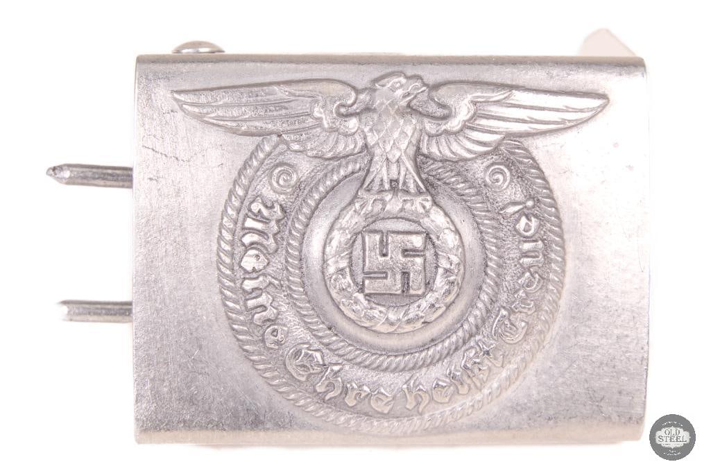 Original WWII German EM/NCO Belt Buckle Field Equipment: This original WWII German EM/NCO belt buckle is a field-issued uniform component from the Second World War. The buckle shows age-related wear consistent with period use, including patina and handling
