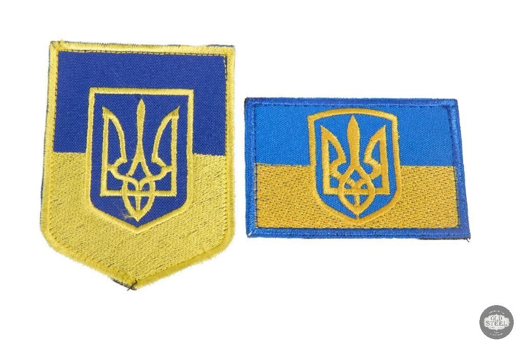 Lot of 2 Ukrainian Blue & Yellow Tryzub Trident Patches Uniform Insignia: This lot includes two Ukrainian uniform patches featuring the blue and yellow color scheme with the Tryzub (trident) national emblem. The patches show light age-related wear consistent with storage an