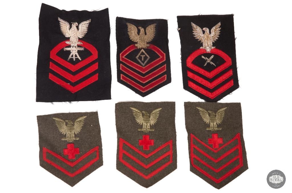 Assorted World War II era US Navy rating badges: This collection features World War II era US Navy rating badges, including various specialist insignias and ranks. Several badges represent the Pharmacist Mate rate, indicated by the red cross symbol 