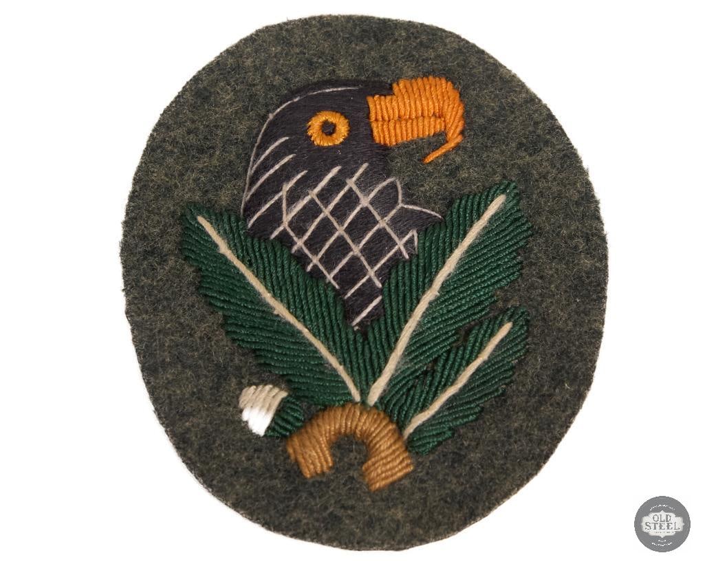 Reproduction WWII German Sniper Badge: This item is a reproduction of a WWII German Sniper Badge (Scharfschutzenabzeichen) Third Class, which was awarded for 20 confirmed kills. It is designed to be worn on the right sleeve of a uniform an
