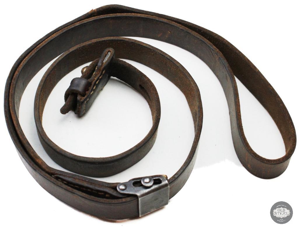 Original WWII German K98k Leather Rifle Sling Mauser Military Issue: This original WWII German K98k leather rifle sling is an authentic military-issued accessory for the Karabiner 98k. Constructed of leather with steel hardware, the sling shows age-related wear, handli