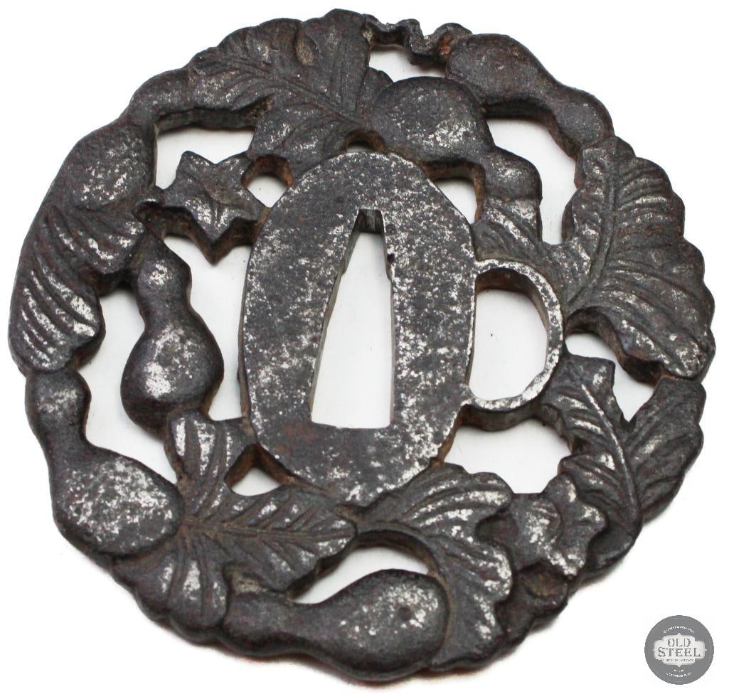 Original Japanese Iron Tsuba Floral Motif Sword Guard Edo/Meiji Style: Original Japanese iron tsuba featuring floral-style decoration. The guard is constructed of iron with cutout and/or relief detailing consistent with traditional Japanese sword fittings. The surface sh