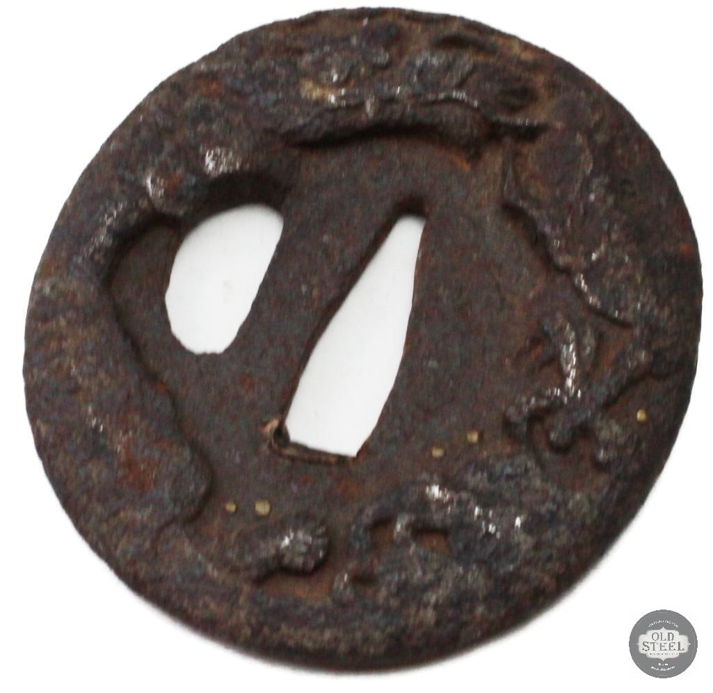 Original Japanese Iron Tsuba Sword Guard Traditional Fitting: Original Japanese iron tsuba sword guard constructed of iron with traditional design elements consistent with Japanese sword fittings. The piece shows age-related wear, patina, and handling marks cons