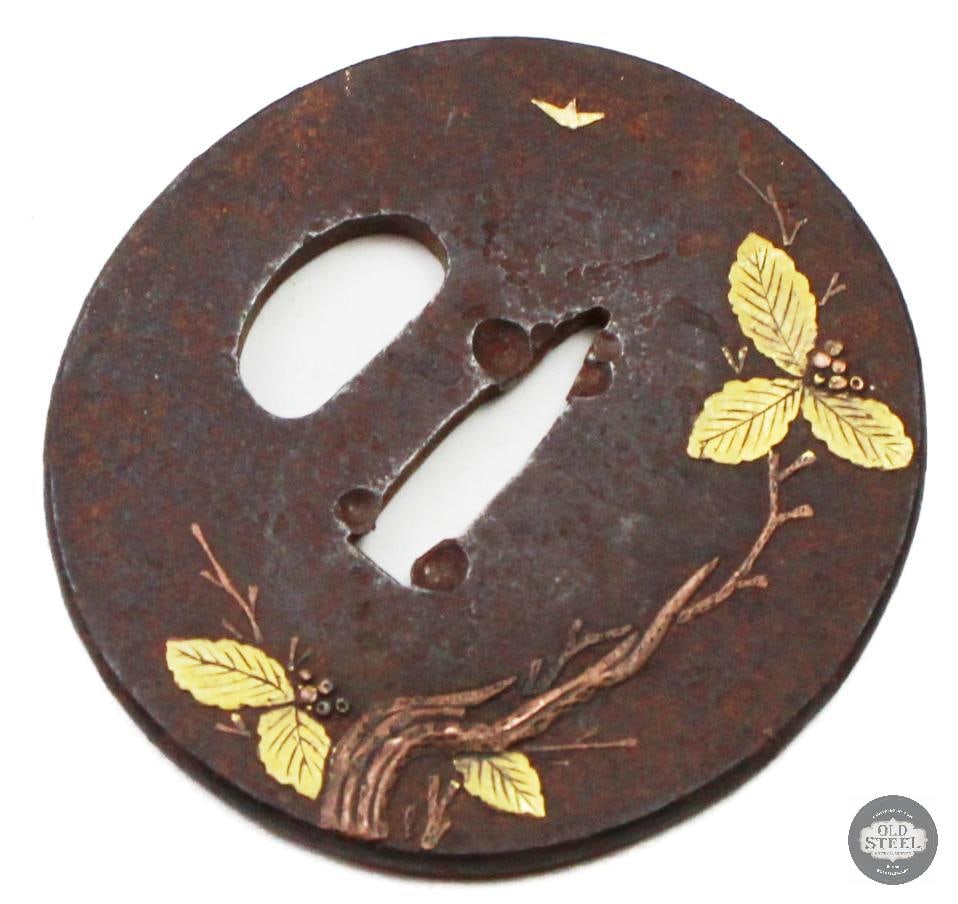 Original Japanese Iron Tsuba Branch & Leaf Motif w/ Gold Looking Inlay Sword Guard: Original Japanese iron tsuba featuring a branch and leaf motif with gold-toned inlay accents on the leaf detailing. The guard is constructed of iron with traditional decorative design work consistent 