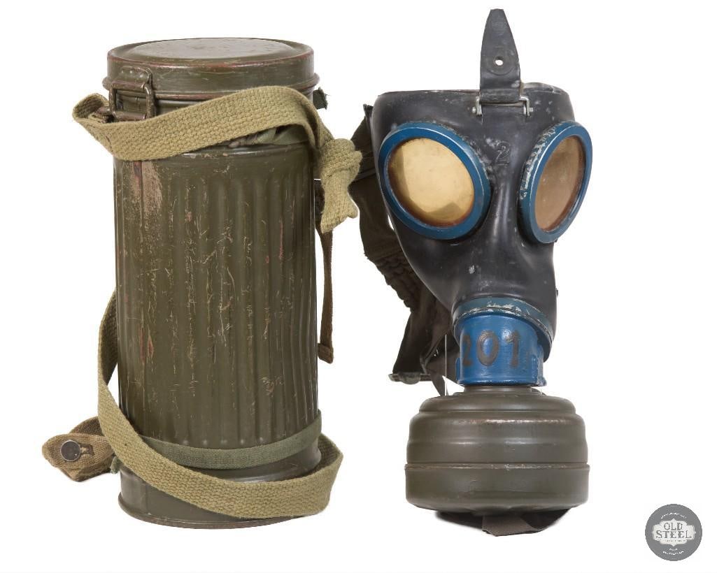 Original WWII German Gas Mask w/ Filter & Carrier C. 1940s Complete Set: Original WWII German gas mask set complete with mask, filter, and carrier. The mask retains its rubber construction, which remains soft and pliable. The set shows age-related wear consistent with stor