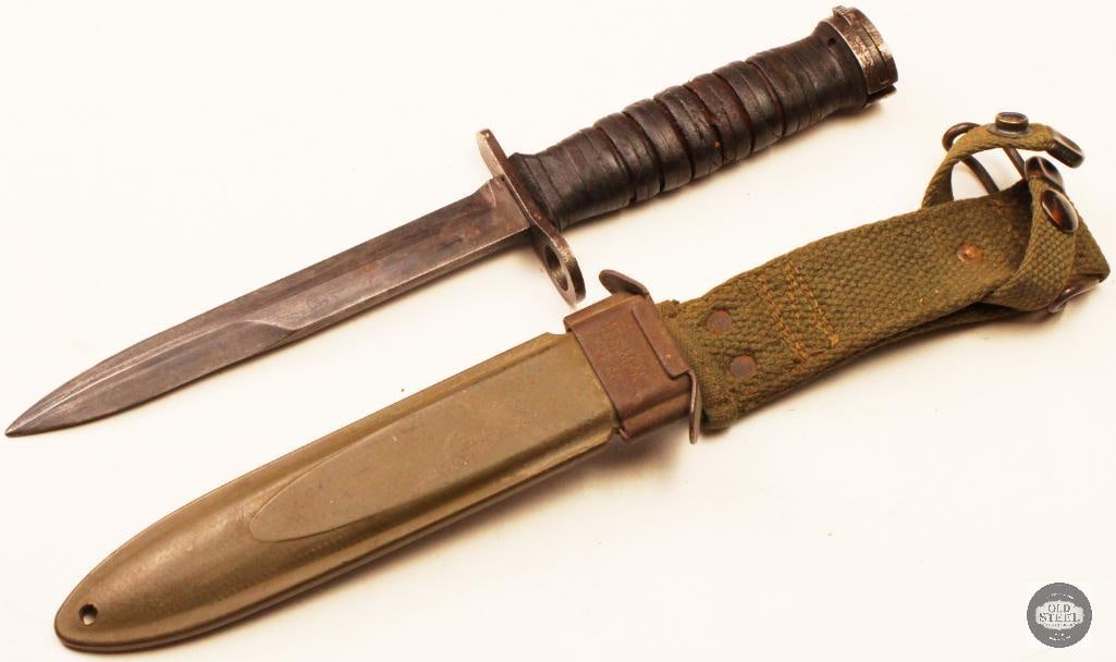 Original U.S. M4 M1 Carbine Bayonet w/ Scabbard: Original U.S. M4 bayonet for the M1 Carbine, complete with its scabbard. The bayonet shows age-related wear, handling marks, and patina consistent with military service and long-term storage. The blad
