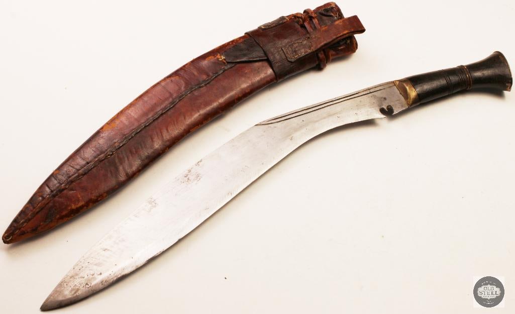 Vintage Kukri Fixed Blade Knife 15" Blade w/ Leather Sheath: Vintage kukri fixed blade knife featuring an approximately 15-inch blade and accompanied by a leather sheath. The knife displays the distinctive forward-curved blade profile that has made the kukri