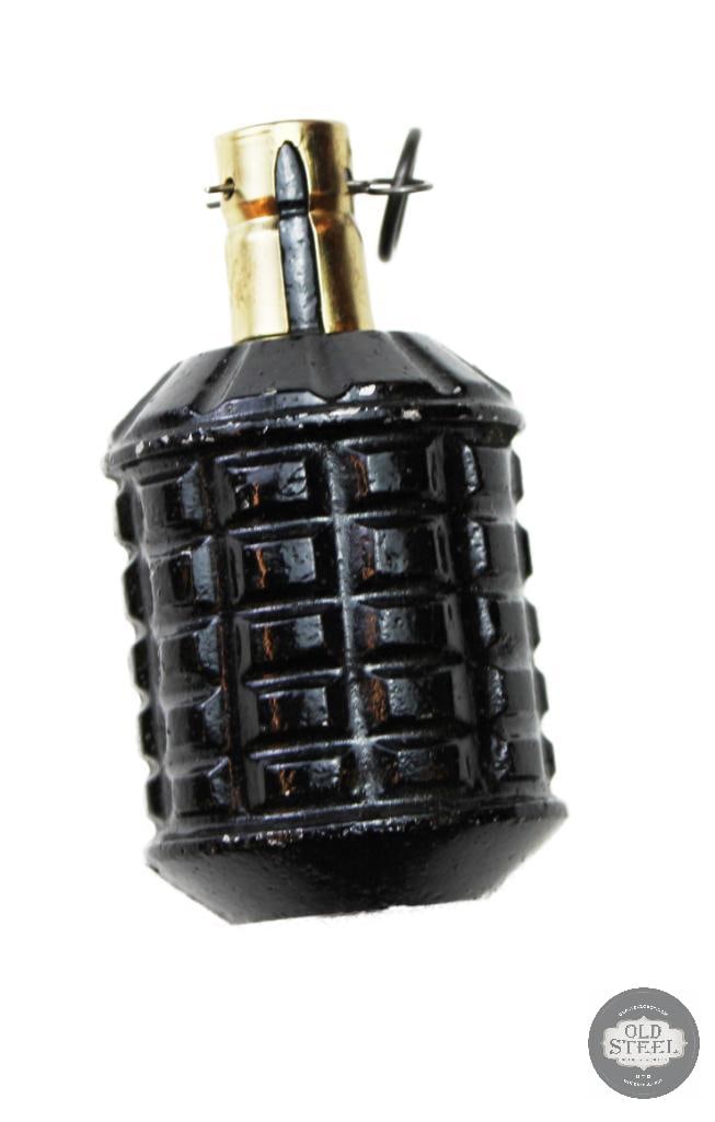 Japanese Type 97 Fragmentation Hand Grenade: This is a Japanese Type 97 fragmentation hand grenade from World War II. It features a distinctive cast-iron body with a serrated surface pattern designed for fragmentation. The top assembly includes