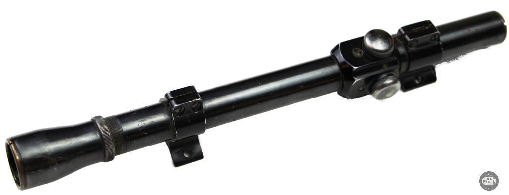 Vintage Weaver Rifle Scope: Vintage Weaver rifle scope, possibly a Model K2.5 or K3, commonly mounted on mid-century firearms. The item includes integrated adjustment turrets for elevation and windage, along with mounting rings.