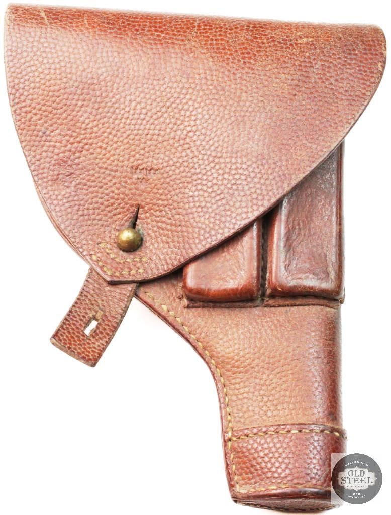 Swedish Leather Holster: This is a vintage Swedish leather holster designed for the Husqvarna M1907 pistol. It features a textured brown leather exterior with an integrated pouch for spare magazines. These holsters were