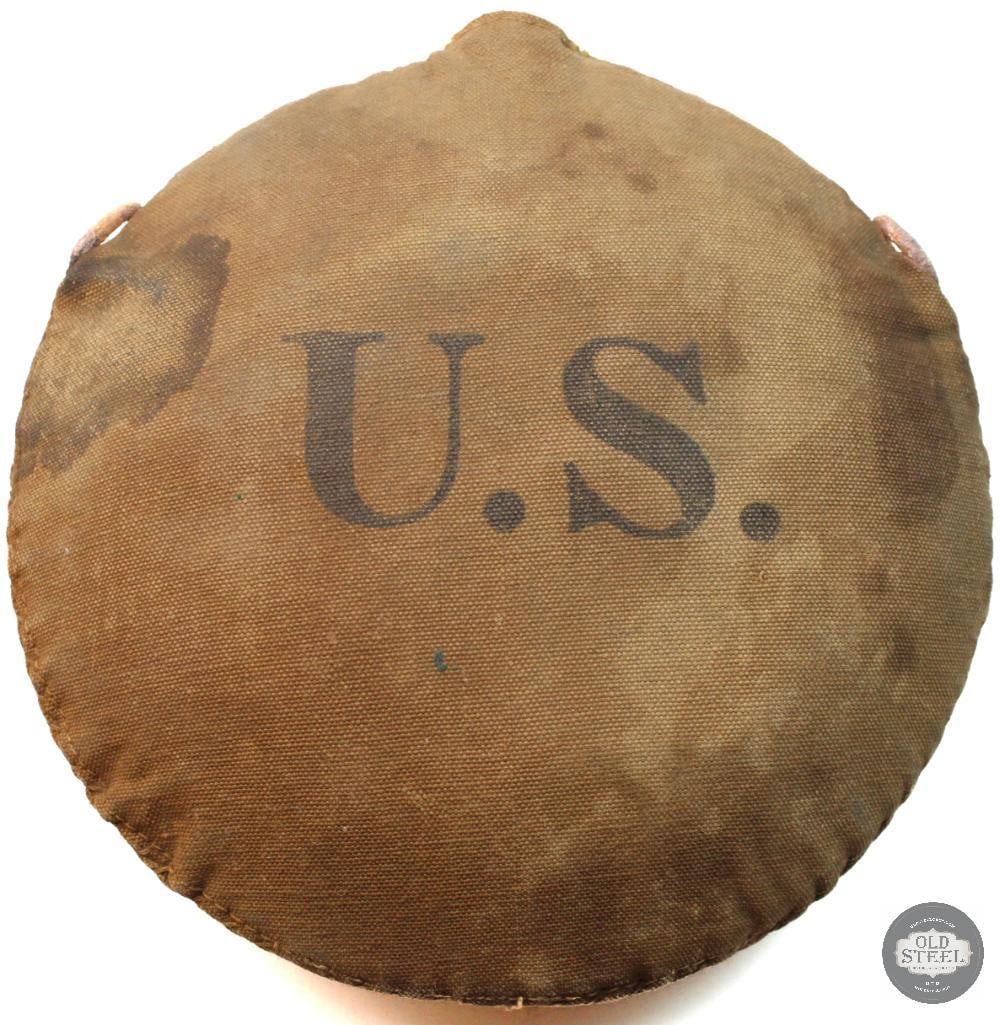 U.S. Army Model 1878 Canteen: U.S. Army Model 1878 canteen from the Spanish-American War era. It features a canvas cover with a bold "U.S." stamp and is often made from modified Civil War-era canteen bodies. Typical features