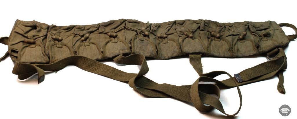 Chinese Military Type 56 canvas ammo pouch: This is a Chinese Military Type 56 canvas ammo pouch designed to hold ammunition for the SKS rifle. The rig features ten pouches and typically uses wooden toggles to secure the closures. These bandoli