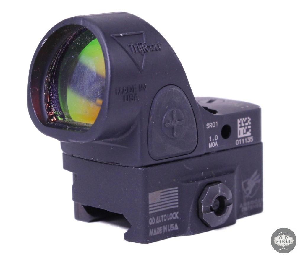 Trijicon SRO Red Dot Sight w/ ADM Low Picatinny Mount: Trijicon SRO red dot sight mounted on an ADM (American Defense Manufacturing) low Picatinny mount. The optic functions great with clear glass and reliable operation. It shows minimal signs of wear, wi