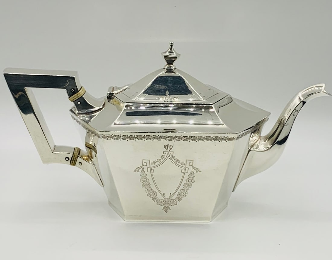 A STERLING SILVER FLAT-BOTTOMED TEAPOT (1 of 3)