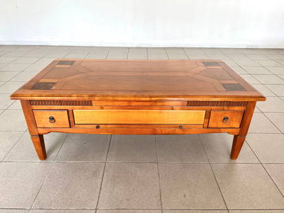 FRENCH MID-CENTURY COFFEE TABLE: Dimensions: H 18” x W 49” x D 25.5”. French Colonial Mid-Century Modern coffee table with figurative inlaid top and storage drawers – 4 small and 1 larger in the center that has a