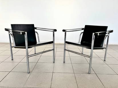 PERRIAND, JEANNERET, LE CORBUSIER LC1 CHAIRS: Dimensions: H 26” x W 23” x D 25” x SH 15.5”. Pair of Charlotte Perriand, Pierre Jeanneret and Le Corbusier, Basculant black leather chairs model LC1. 023