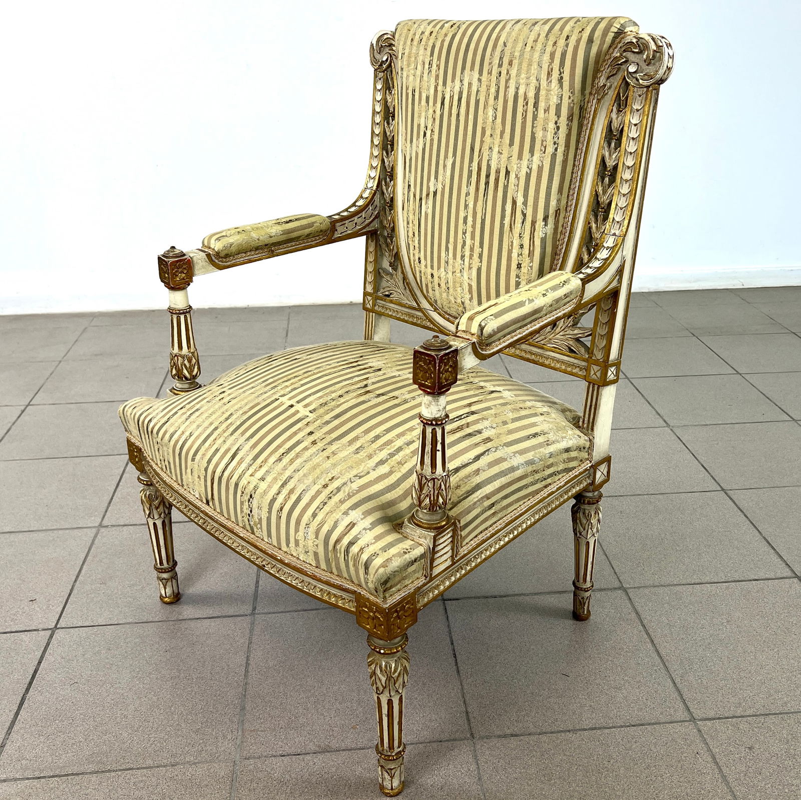 FRENCH DIRECTOIRE STYLE ARMCHAIR: Dimensions: H 34.7" x W 22" x D 21" x SH 17". French Directoire style carved giltwood armchair with original upholstery. 043