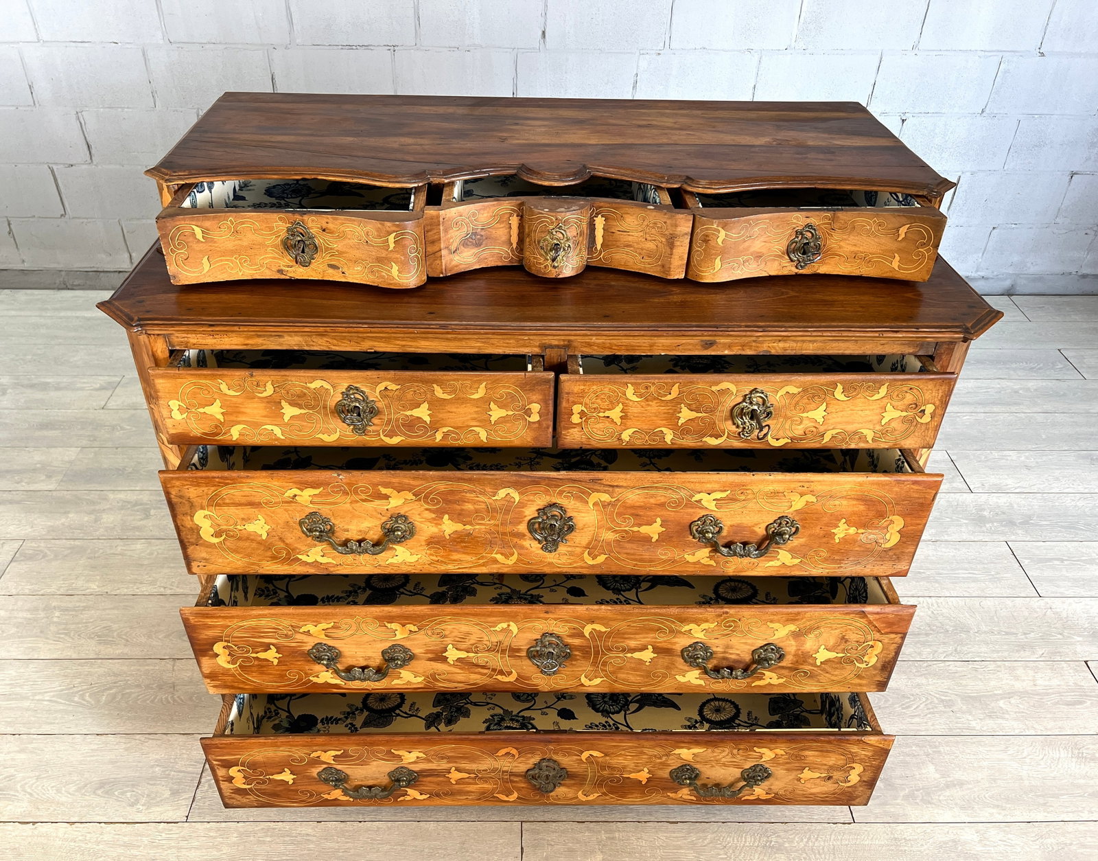 ANTIQUE ITALIAN INLAID CHEST OF DRAWERS: Dimensions: H 44.5" x W 53.5" x D 26.5". Italian inlaid chest of drawers with 8 drawers, each one with original blue and white floral fabric inside. 052