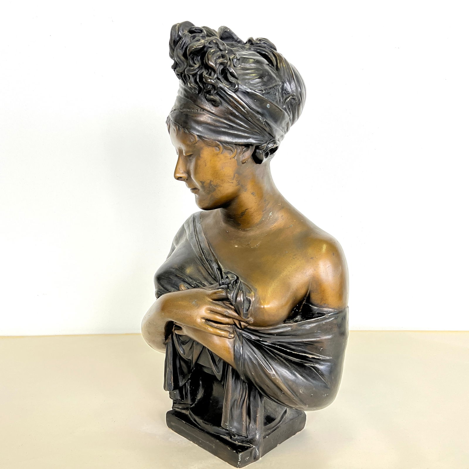 BUST OF MADAME RECAMIER, AFTER JEAN-ANTOINE HOUDON: Dimensions: H 22.5” x W 12” x W (base) 6”. Antique French imitation bronze bust of Madame Recamier, after Jean-Antoine Houdon. Flat rate shipping to US available.