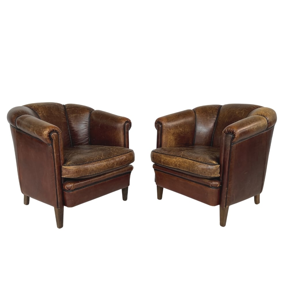 (2) DUTCH VINTANGE LEATHER CLUB CHAIRS: Dimensions: H 30.5” x W 30” x D 33” x SH 18.5”. Pair of Dutch brown leather club chairs with removable cushions.