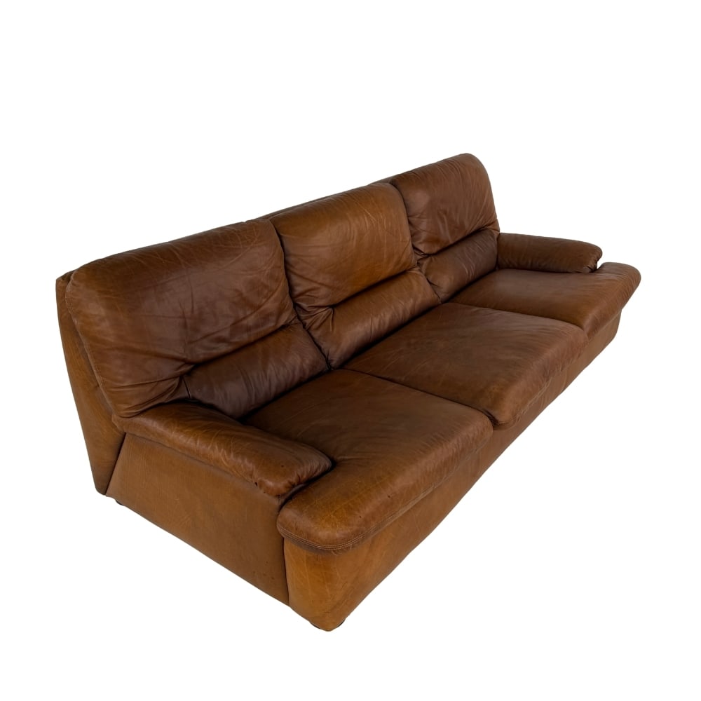 LEATHER THREE-SEAT SOFA BY ROCHE BOBOIS: Dimensions: H 32” x W 84” x D 37.5” x SH 16”. Brown leather three-seat sofa attr. to Roche Bobois.
