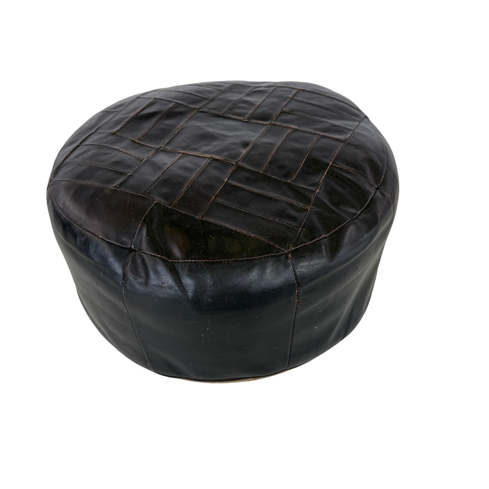 DE SEDE DS-80 LEATHER POUF: Dimensions: H 12” x W 24”. De Sede DS-80 black leather patchwork pouf.