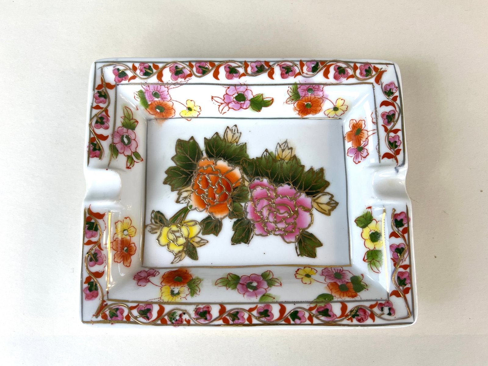 ANTIQUE PORCELAIN ASHTRAY: Dimensions: H 1.7” x W 7.3”. Antique porcelain ashtray for 2 cigarettes with floral ornaments. Flat rate shipping to US available.