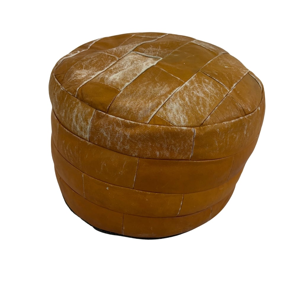DE SEDE LEATHER POUF, 1970s: Dimensions: H 12” x W 19”. Vintage patchwork brown leather pouf from De Sede.
