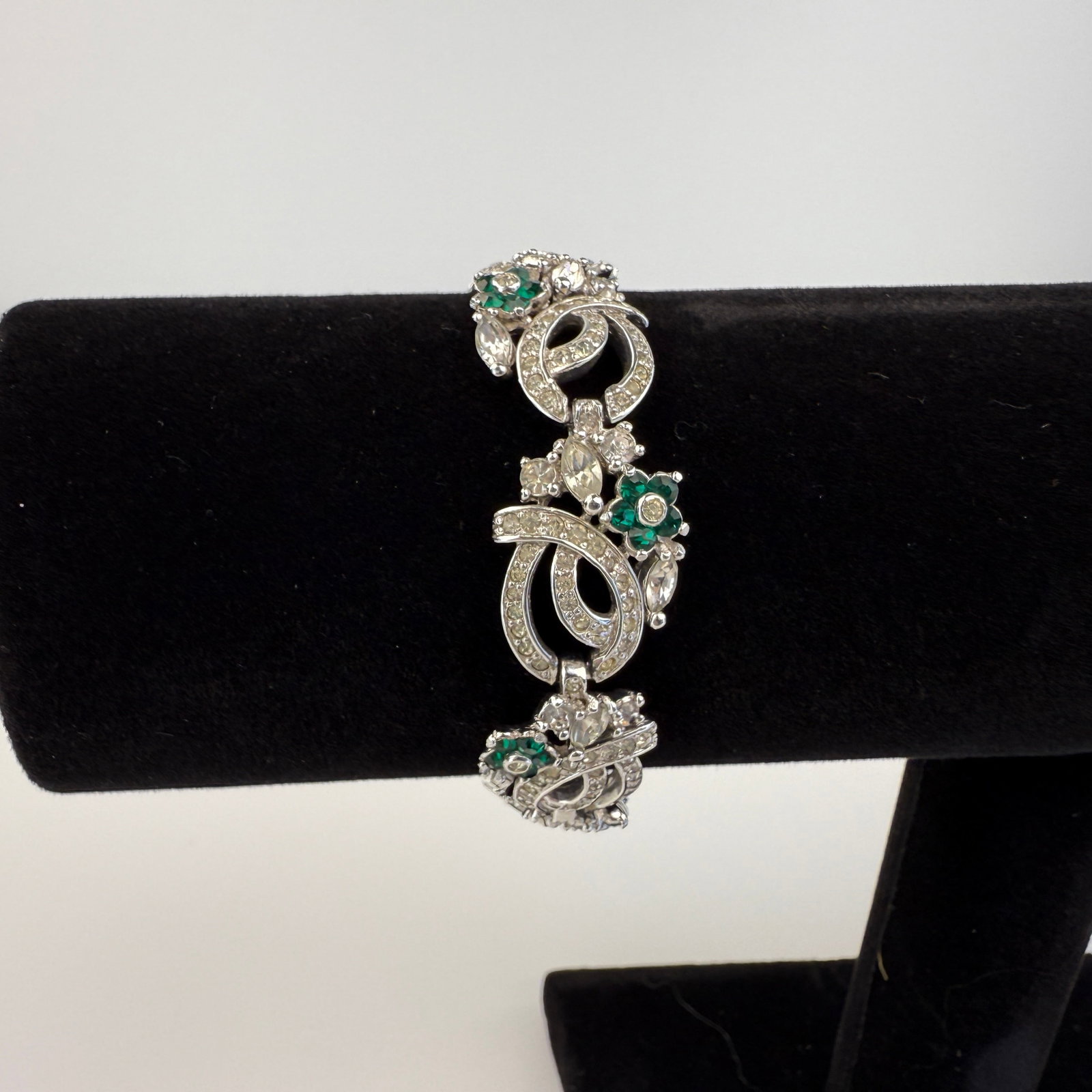 PENNINO BRACELET: Dimensions: W 7”. Vintage Pennino floral bracelet with white and green rhinestones.