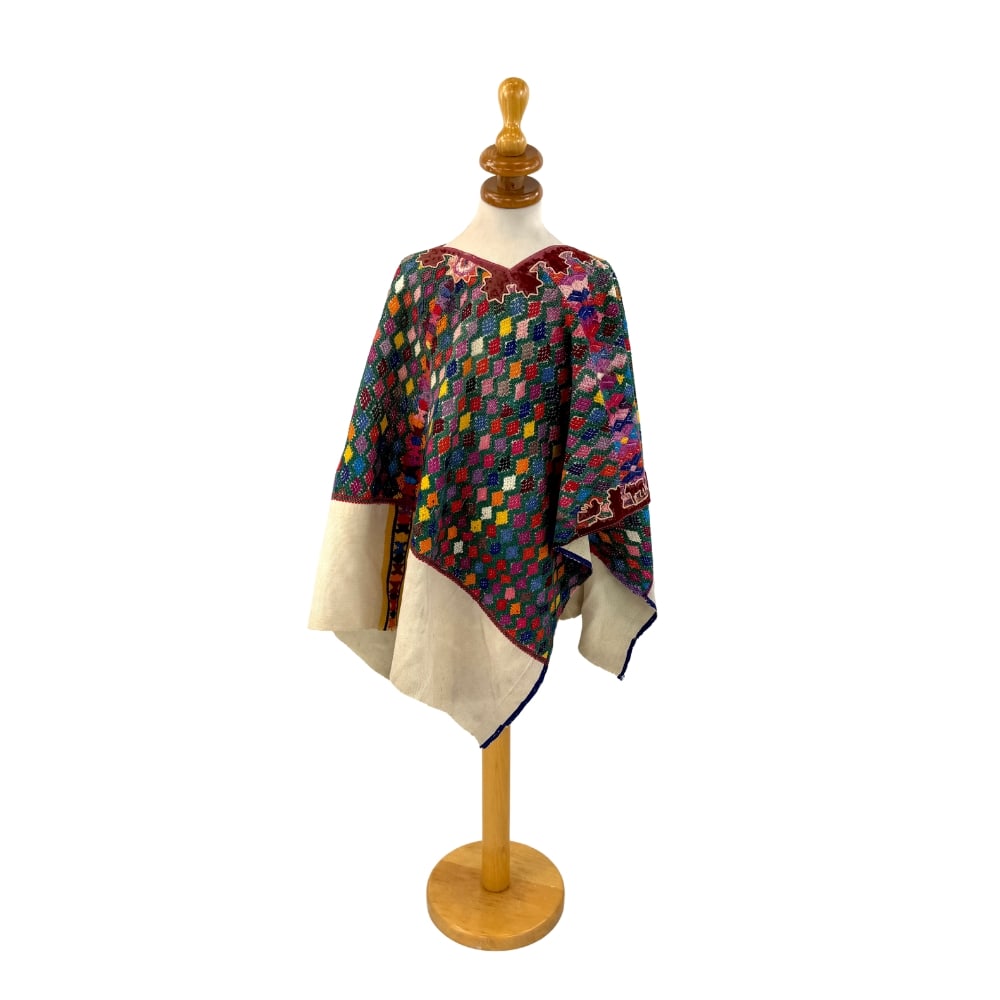 VINTAGE HANDWOVEN HUIPIL: Dimensions: H 36.5” x W 51”. Vintage handwoven Guatemalan Mayan huipil with multi-color geometric pattern.