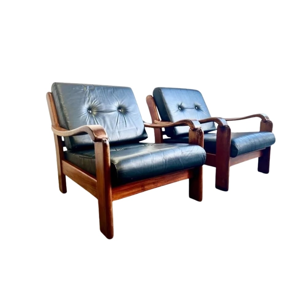 DANISH ARMCHAIRS MANNER OF HOLSTEBRO, A PAIR: Dimensions: H 29.9” x W 35” x D 30.3”. Pair of Vintage Danish armchairs manner of Holstebro with teak frame and original black faux leather loose padded cushions.