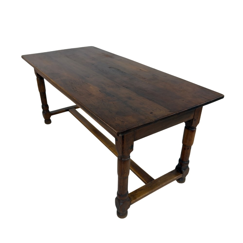 FRENCH FARMHOUSE DINING TABLE: Dimensions: H 29.5” x W 67.3” x D 31”. Vintage French Farmhouse solid oak dining table with four turned legs with stretcher.